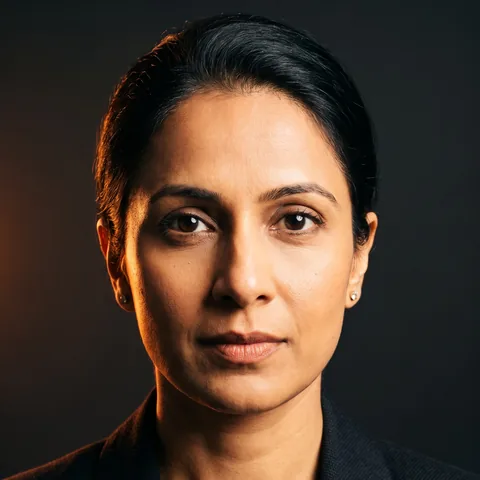 Studio portrait of Priya, a precise detail-first FirstHire persona (AI-generated, synthetic).